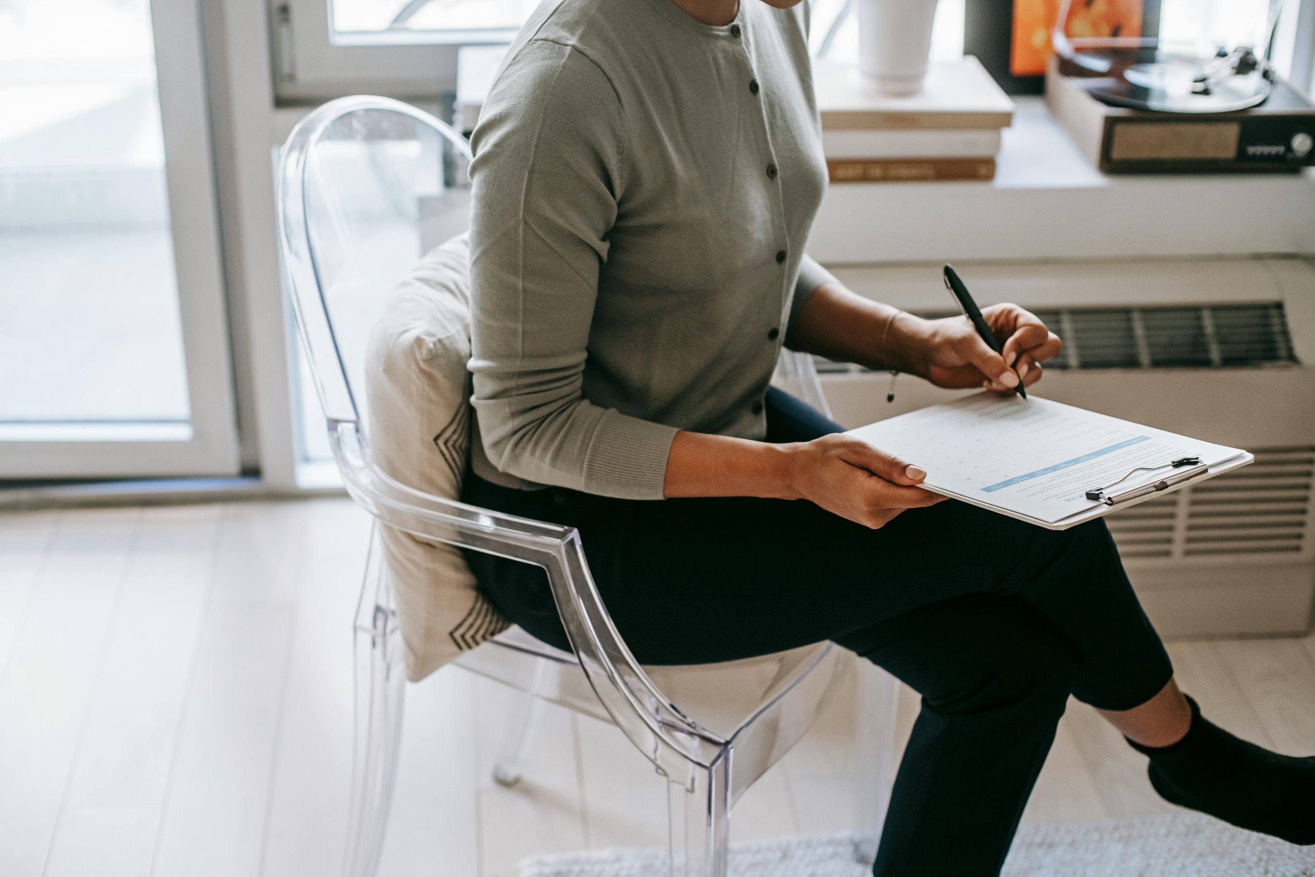 Registered psychologist in Calgary taking clinical notes during a therapy session