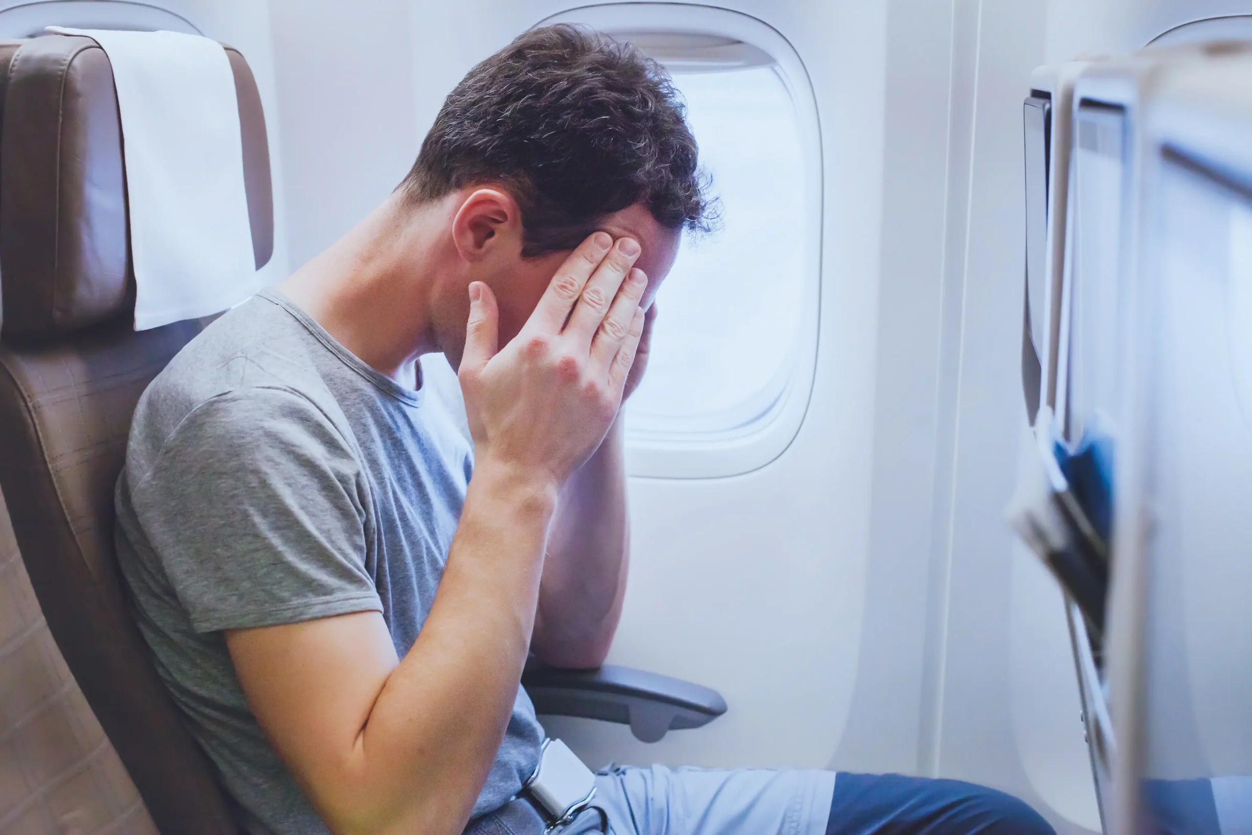 Man on a plane experiencing symptoms of phobia anxiety treated by Calgary psychologist with ART and exposure therapy