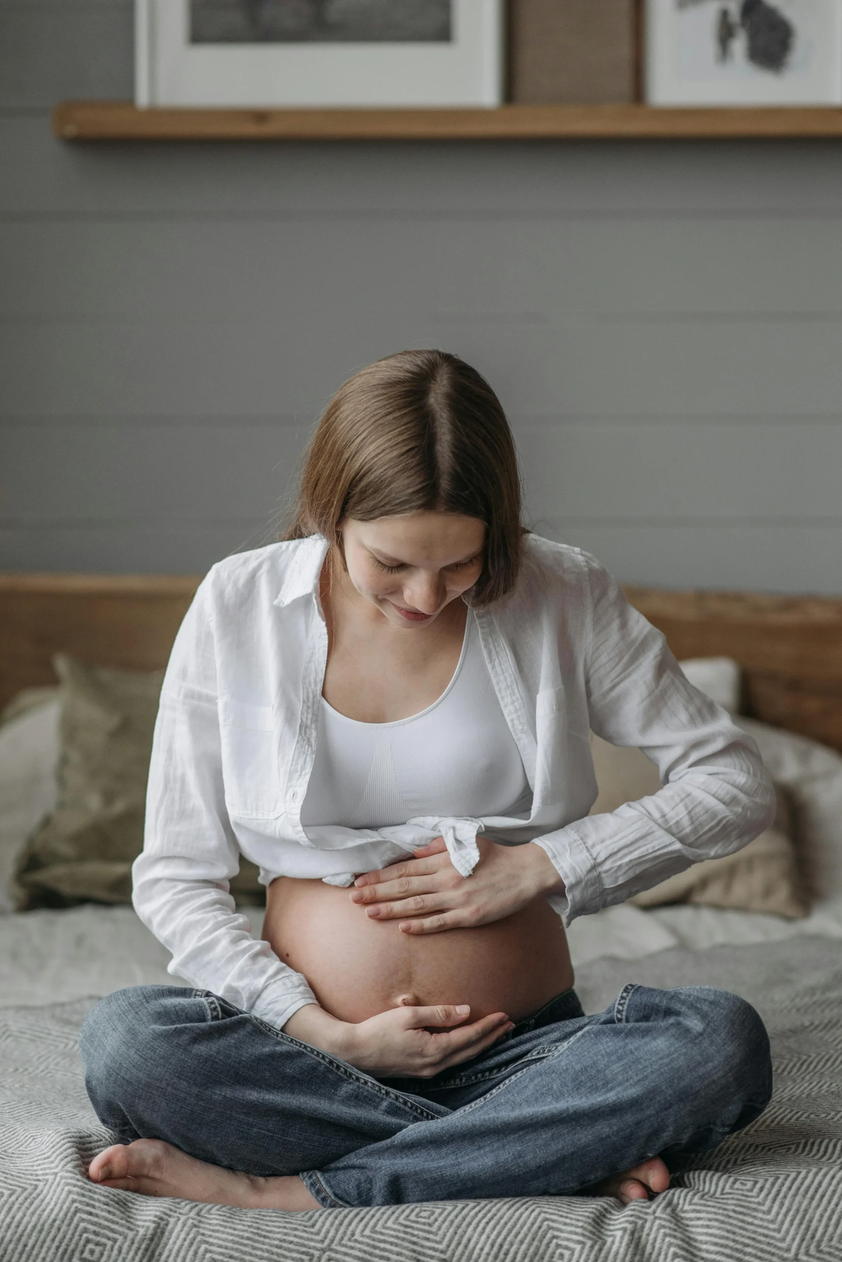 Pregnant woman holding her baby bump illustrating life transitions that Calgary psychologists can help with